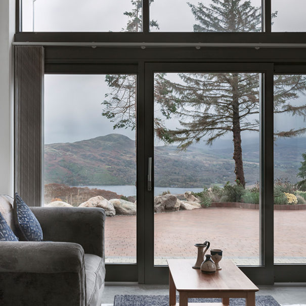 Living room with a floor to ceiling window view onto the mountains and valleys in the Reeks